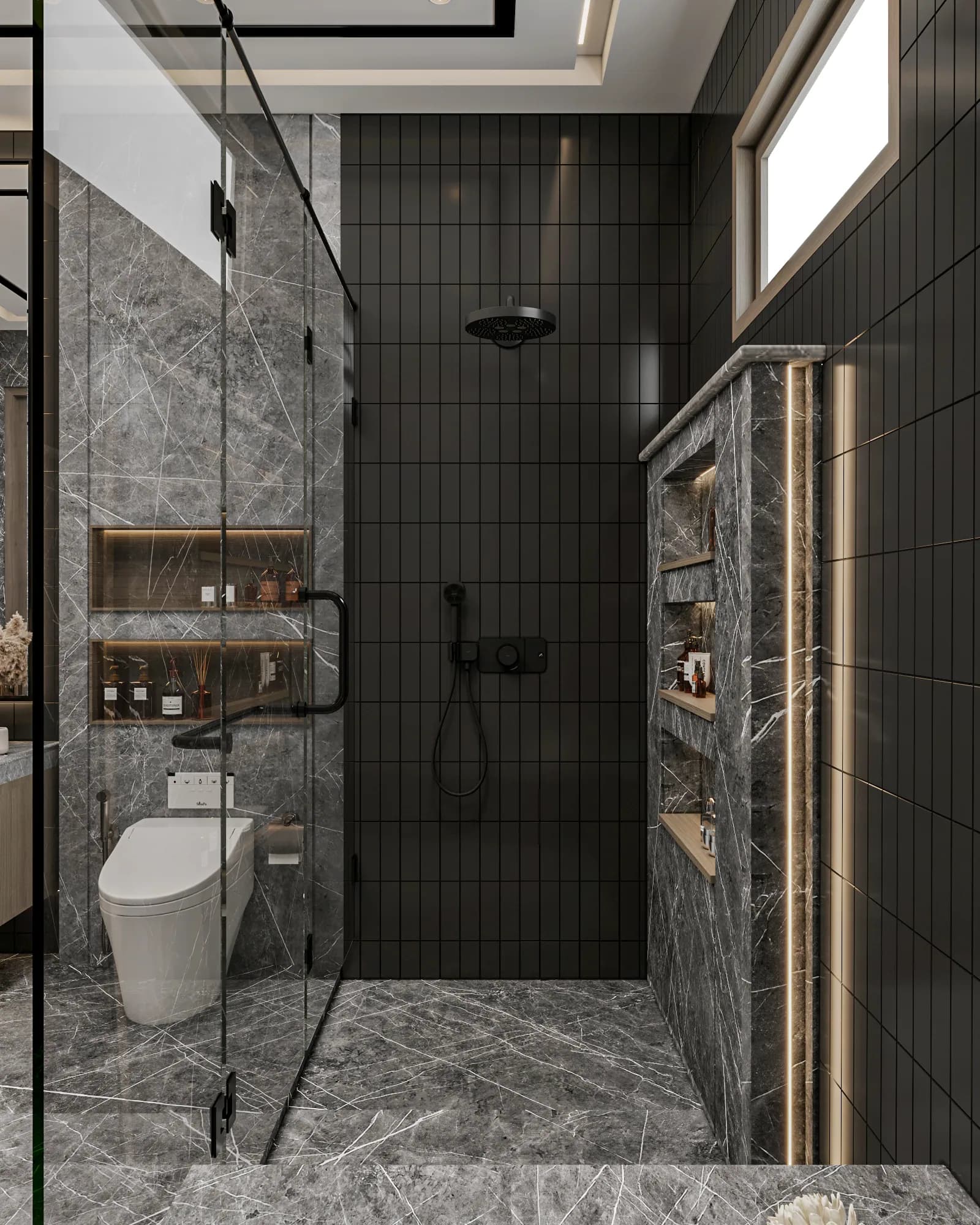 Family Residence: Black shower fittings sit against narrow dark tiles beside a tall recessed shelving unit, outlined by warm strip lighting beneath the high window.