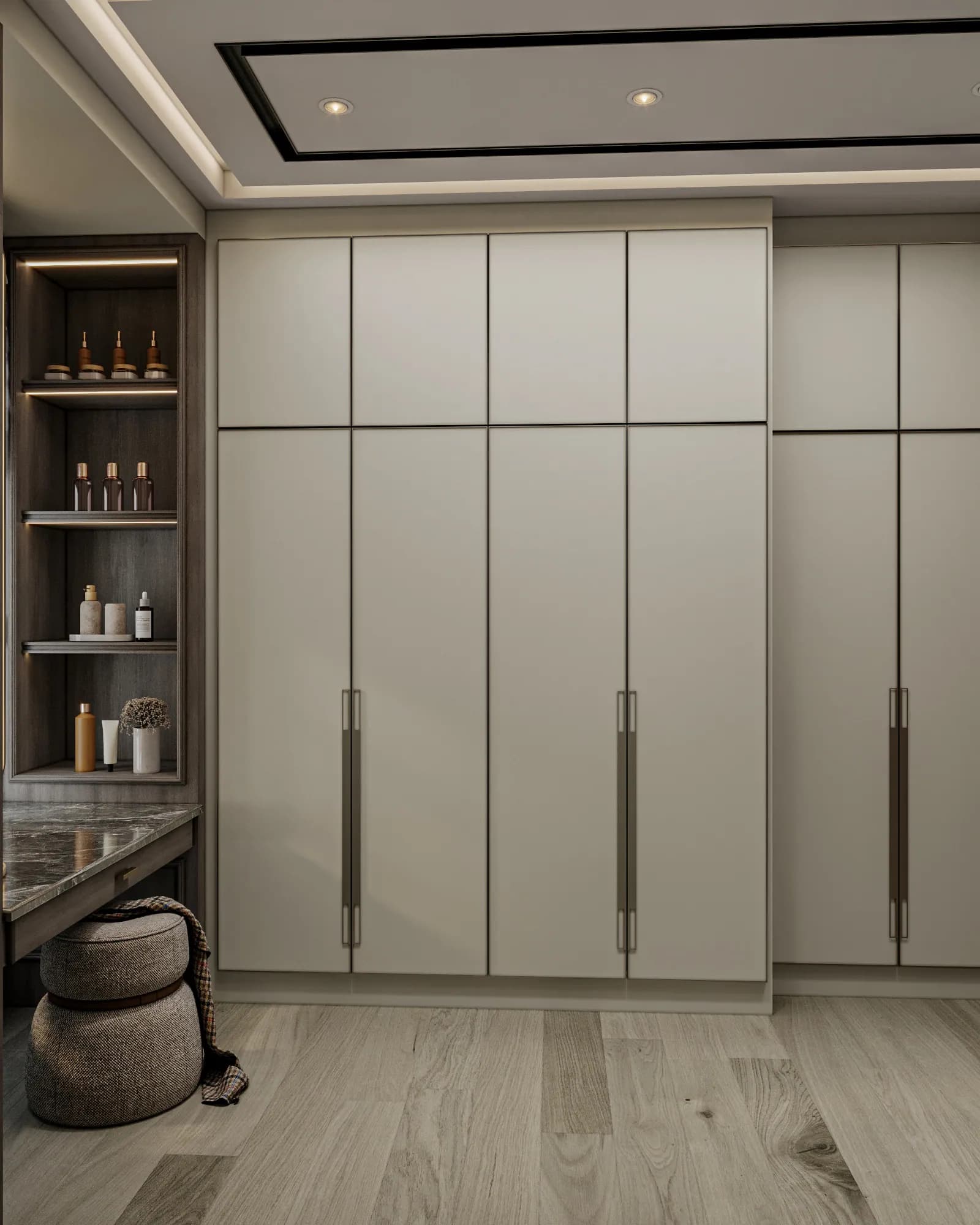 Family Residence: The dressing corner combines closed pale cabinetry, illuminated accessory shelves, a veined tabletop and a rounded upholstered stool.