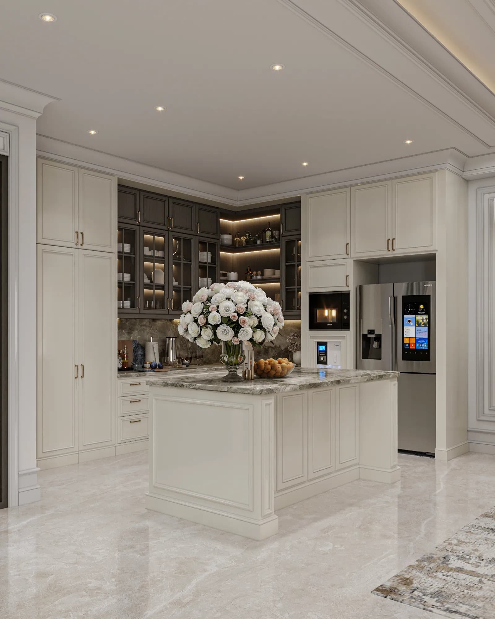 Family Residence: An angled kitchen view shows the island beside tall closed cupboards, lit glass-front storage and a refrigerator integrated into the cabinet wall.